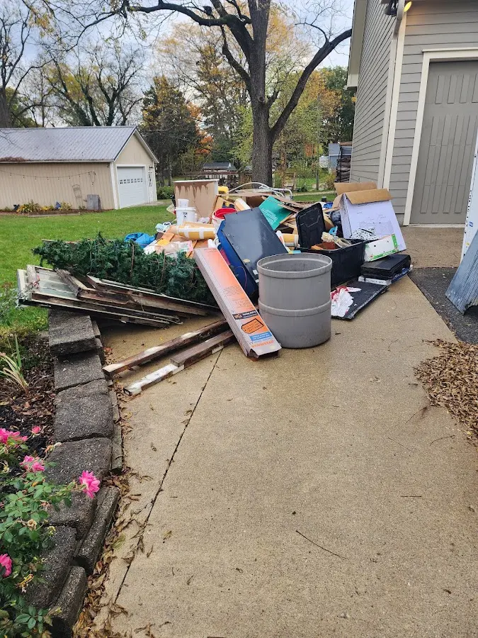 Dumpster being loaded with debris for Commercial Dumpster Rental in Park Hills